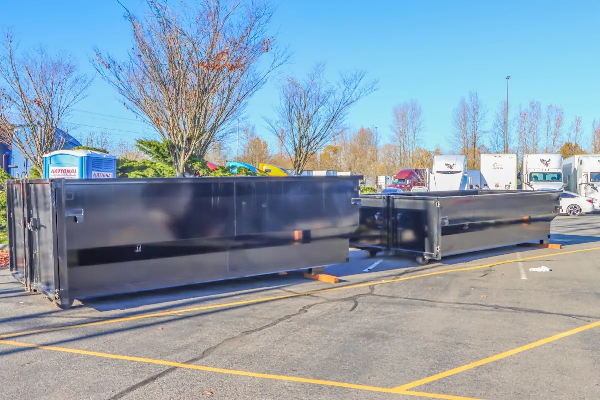 Professional dumpster rental service with roll-off container on residential driveway in Danbury